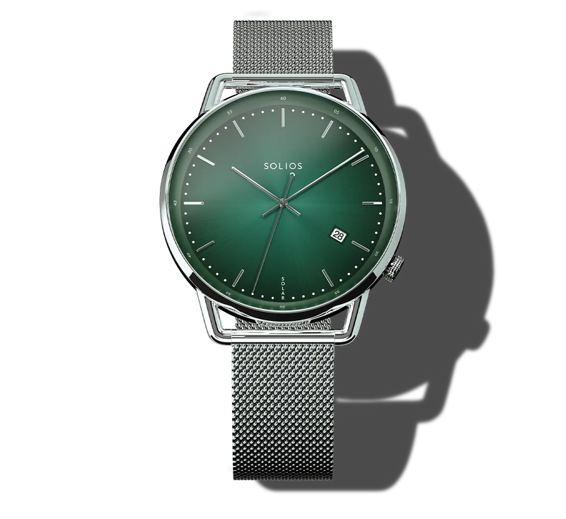 A Solios Curve solar analog watch with a green gradient dial and a silver stainless steel mesh strap, shown on a white background with a soft shadow.