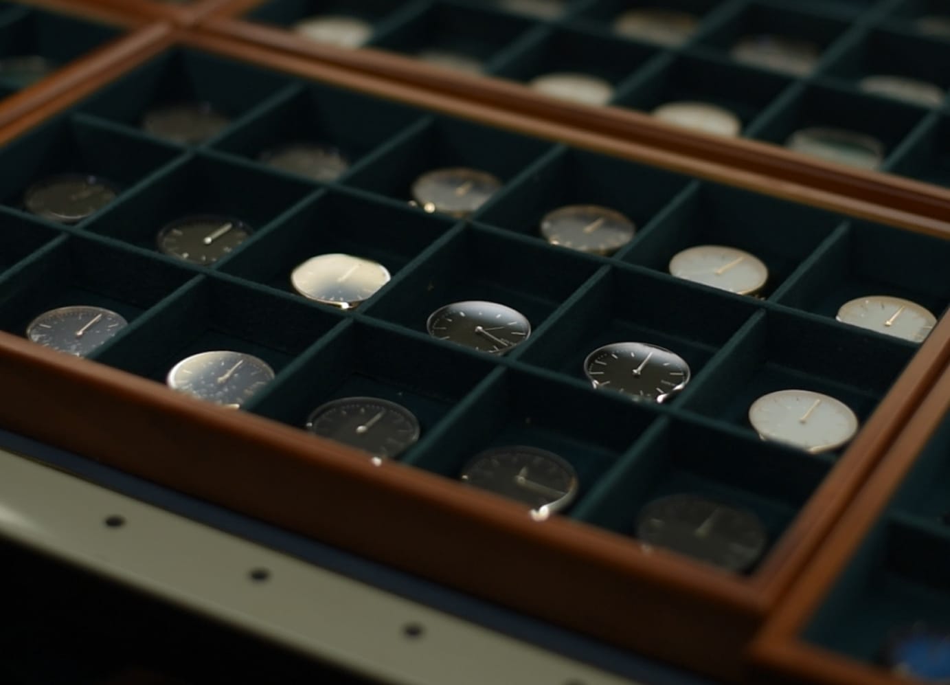 Tray of Solios watch dials in a workshop display case