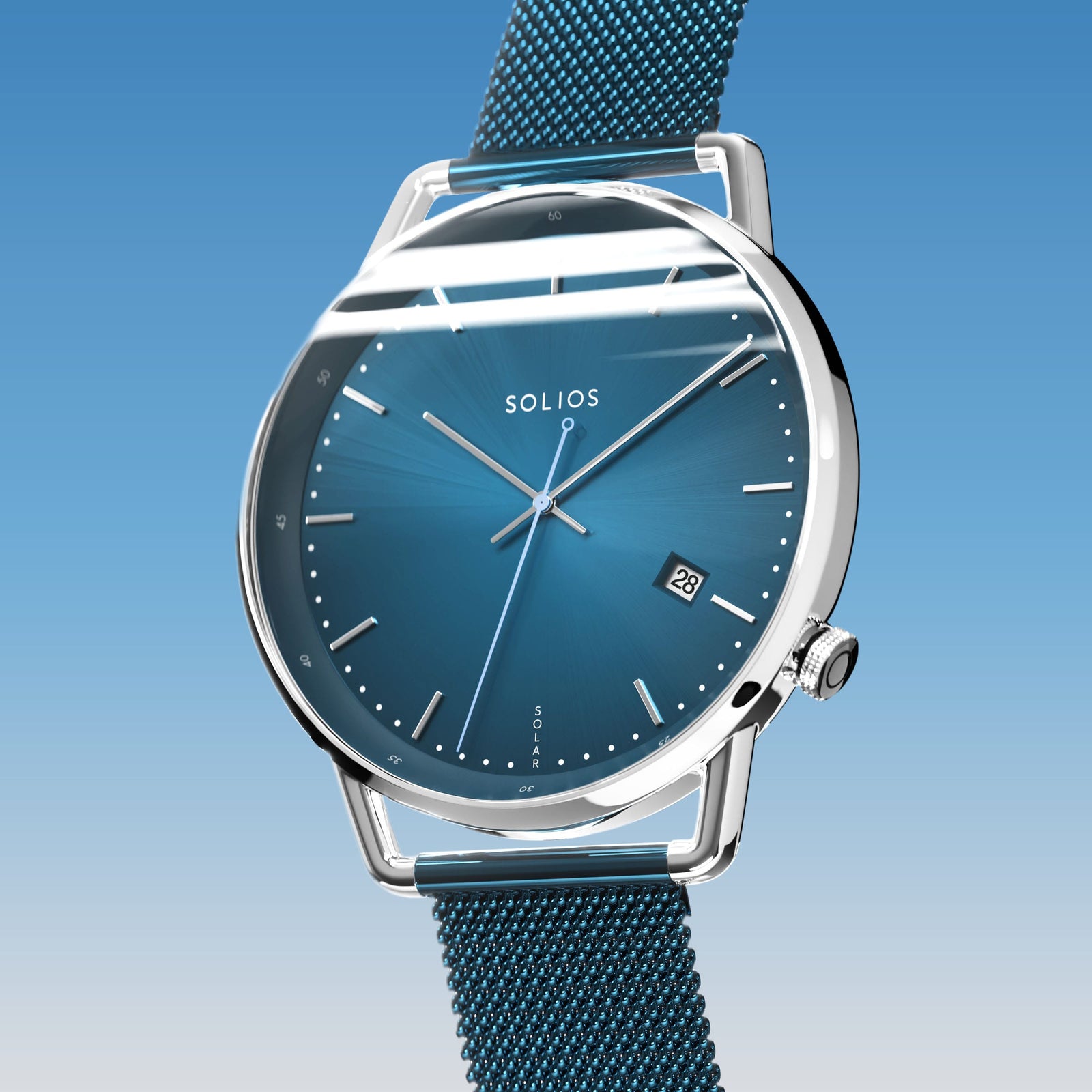Solios Solar Curve, blue dial and silver case, at a three-quarter angle, silver hands and indices, date calendar, curved sapphire crystal, blue mesh metal strap
