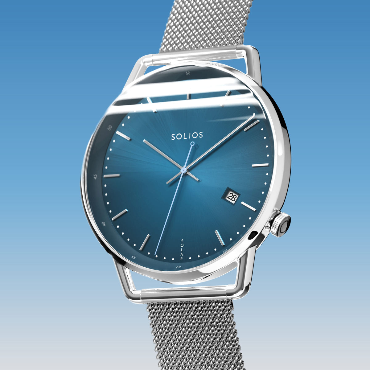 Solios Solar Curve, blue dial and silver case, at a three-quarter angle, silver hands and indices, date calendar, curved sapphire crystal, silver mesh metal strap