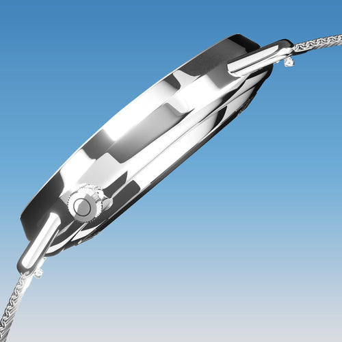 Side profile of the Solios Solar Curve, blue dial and silver case, showing its curved sapphire crystal and crown, silver mesh metal strap