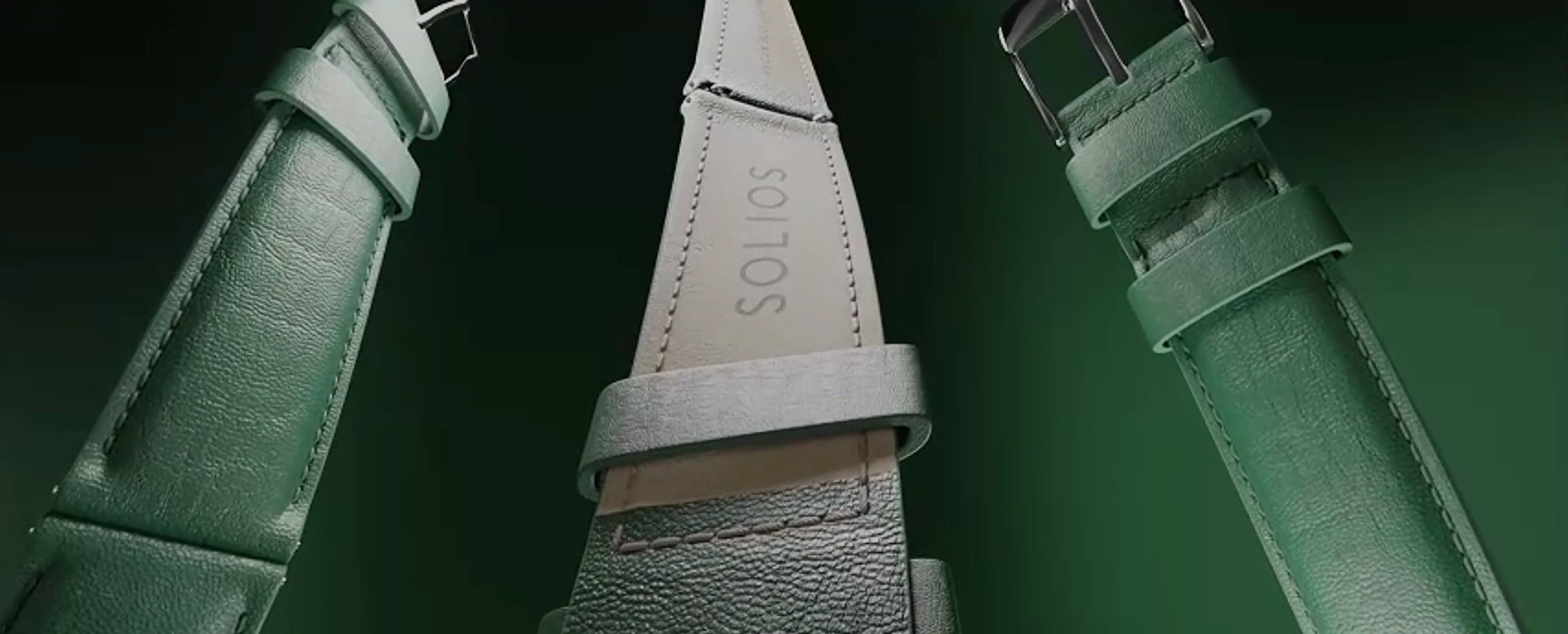 Close up of three green eco vegan leather straps from Solios, twisted on a green background