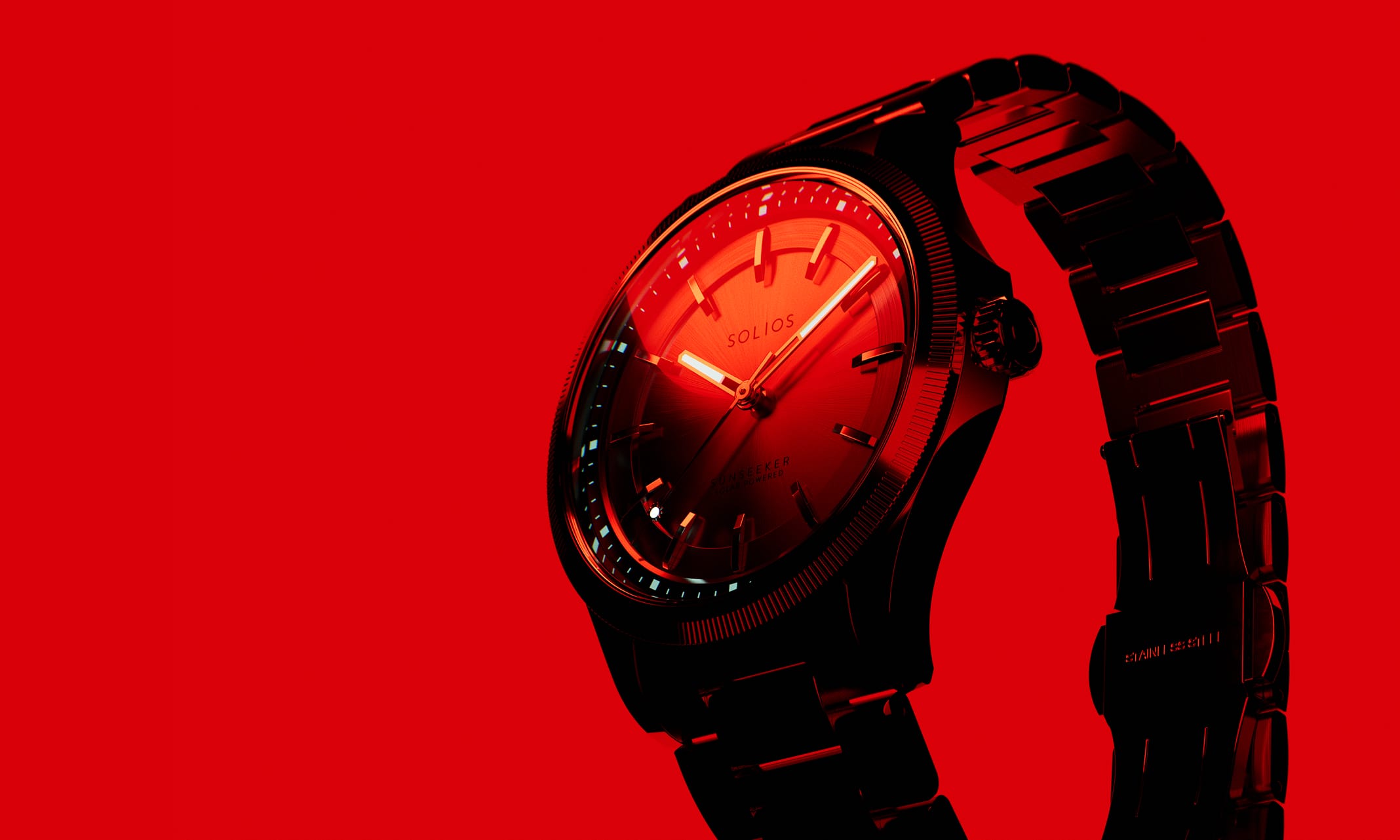 Solios Sunseeker solar watch, black dial and steel bracelet, on a red background