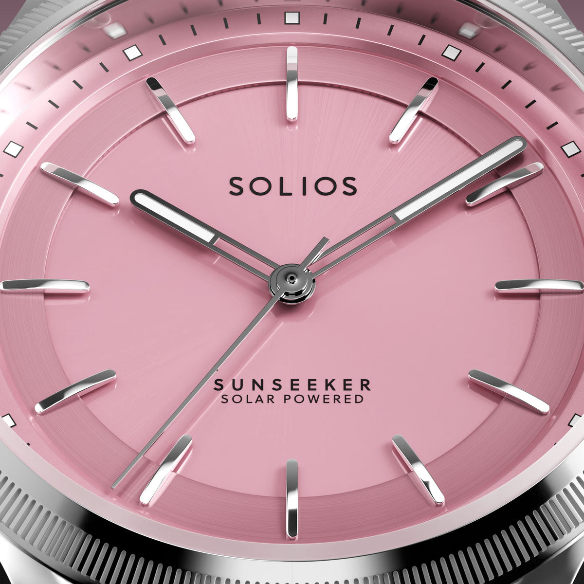 Macro of the Solios Sunseeker pink dial with luminous floating indices and ray-cut bezel edge